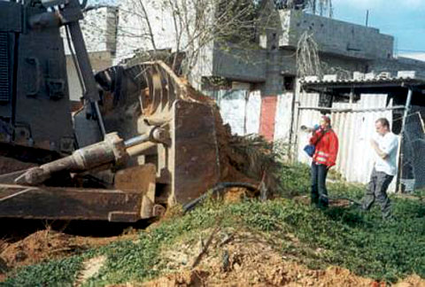 Rachel Corrie, along with other members of the International Solidarity Movement (ISM) attempt to prevent the destruction of Palestinian homes by Israeli bulldozer.